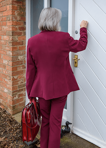 Annie knocking at a front door