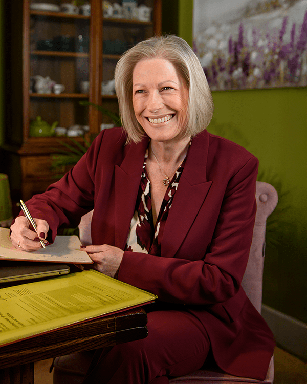 Annie Smiling Sitting At Desk