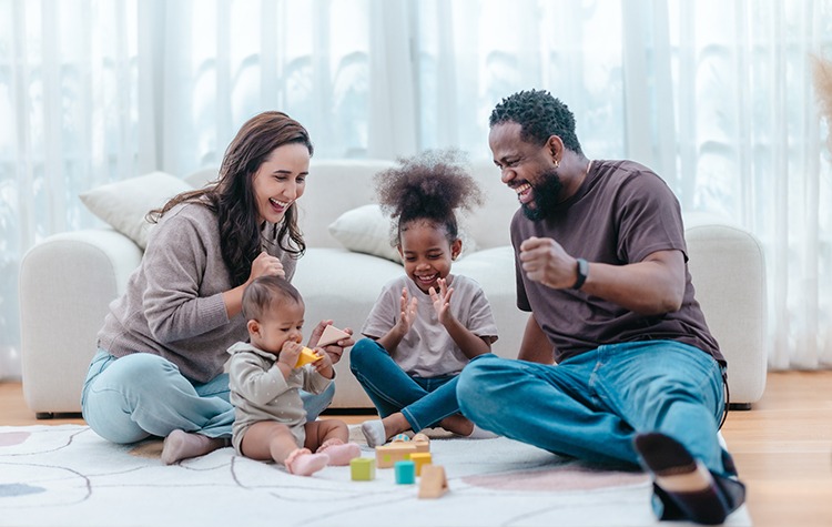 Heartwarming scene of diverse family spending quality time together in living room. The group includes parents and two children, showcasing love, connection, togetherness in modern family setting
